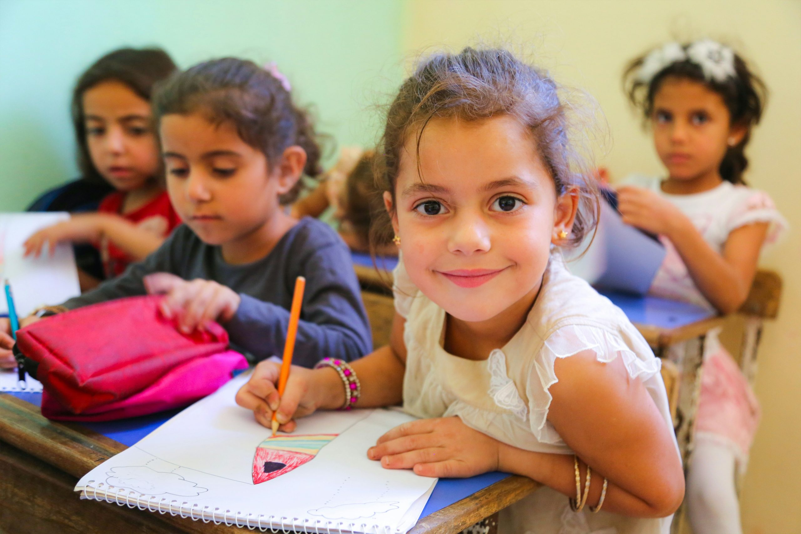 Young students working at their desks in a classroom